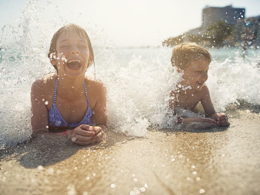 children enjoying the waves