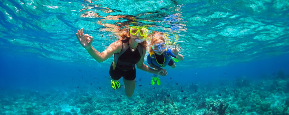 Underwater picture taken of an adult and a child snorkelling