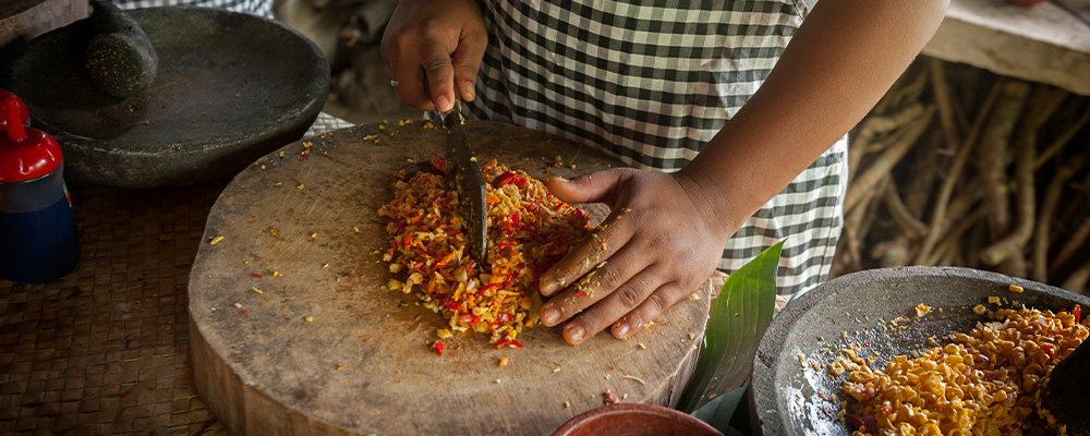 Hands chopping cooking ingredients